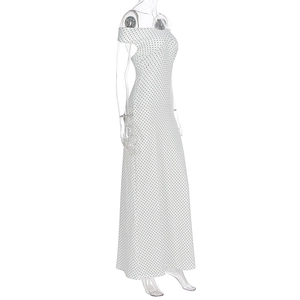 Detailed side view of an off-shoulder polka dot maxi dress with a slim fit silhouette