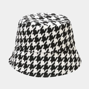 Detailed close-up of heavy tweed fabric texture on a houndstooth fisherman hat