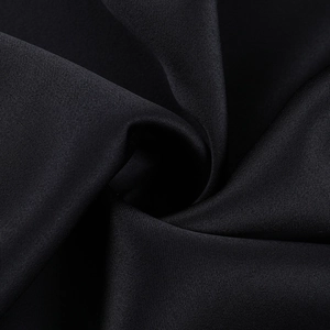 Macro shot of high-quality black satin fabric texture with elegant drape and soft sheen
