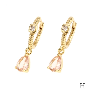 Detailed macro view of 18K gold-plated earring with pink teardrop crystal and square stone