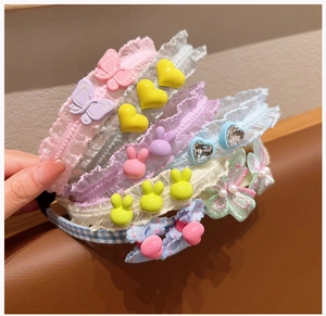 Detail of four colorful lace headbands with butterflies and cute bunny ornaments for girls