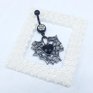 Detailed view of gothic heart spider web belly ring with black stones and rhinestones