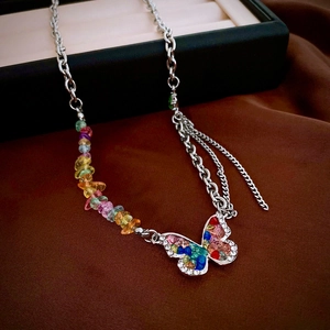 Sparkling butterfly pendant necklace with colorful stones on an asymmetric silver chain