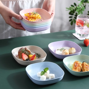 Set of five colorful eco-friendly square plastic fruit plates with elegant golden edges