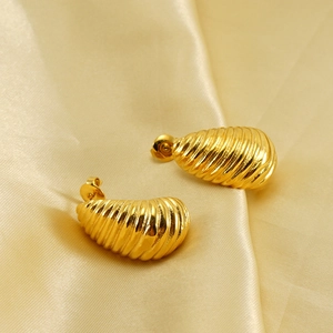 Vintage 18K gold plated titanium steel spiral teardrop earrings on champagne satin