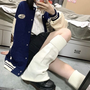 Navy blue baseball jacket with white knit leg warmers in a vintage school girl style