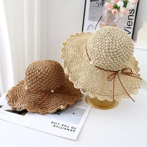 Handwoven sun straw hats with scalloped edges and floral bow knots for summer beach