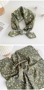 Detail of floral olive green square neckerchief with delicate rolled edge and bow tie