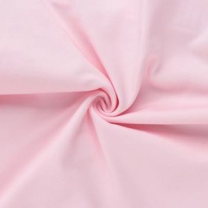 Detail of soft pale pink fabric texture showing elegant knit luster and flexible fibers