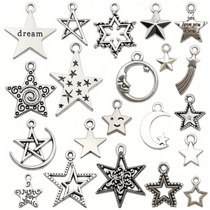 Antique silver star and moon alloy charms for DIY jewelry making on white background