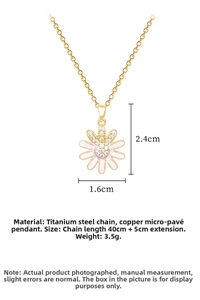 Macro detail of a pink enamel daisy pendant with zircons and gold titanium steel chain