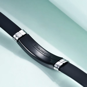 Macro shot of 12mm black silicone strap with silver stainless steel buckle detail