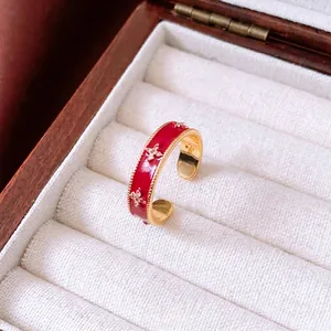 18k gold plated open flower ring with red enamel and star zircon in a wooden box