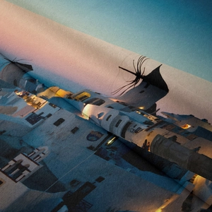 Macro detail of high-quality woven fabric texture with Santorini sunset landscape print