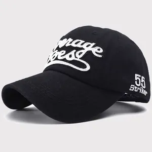 Detailed close-up of 55 Striker embroidery on black cotton twill baseball cap