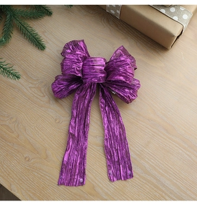 Macro detail of purple metallic glitter bow with wire edge on wooden background