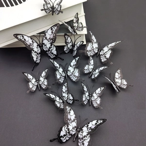 Detailed view of 12-piece black and white 3D butterfly wall stickers with skull patterns