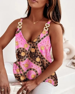Detail of pink floral halter top featuring gold decorative rings on chain straps
