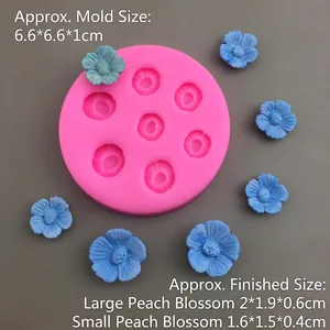Macro shot of pink silicone cherry blossom mold with blue floral resin samples