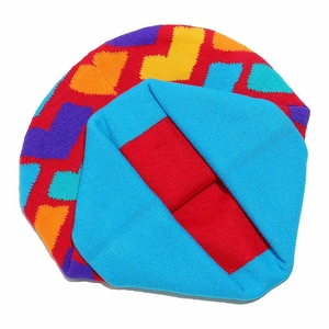 Detailed close-up of chunky colorful patchwork knit beanie with geometric pattern