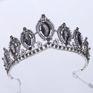 Close-up of silver baroque bridal crown with dark grey crystals and rhinestones