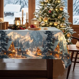 Detail of Christmas tablecloth with snowy village print, pine trees and cozy winter houses