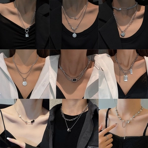 Set of 9 trendy silver necklaces in diverse designs including locks, coins, and hearts