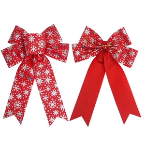 Set of two red Christmas bows with silver snowflake patterns for festive holiday decoration
