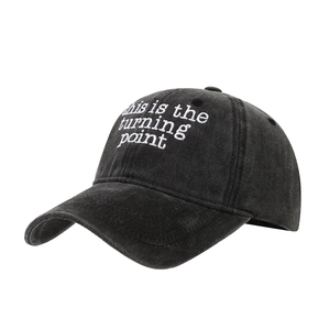 Washed black cotton baseball cap with white embroidered letters in a vintage style