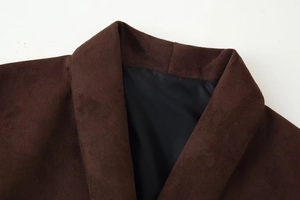 Detail of dark brown faux suede jacket collar with visible stitching and smooth black lining