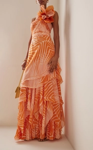 Detail of orange floral shoulder ornament and pleated ruffled hem on maxi dress