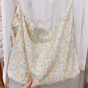 Detailed macro view of yellow floral pattern and soft cotton fabric of the tote bag