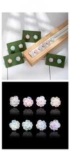Detailed tile display of resin camellia flower studs with colorful iridescent aurora coating