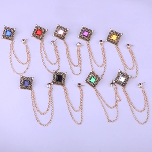 Detailed view of colorful square gemstone brooches with golden chains for suits