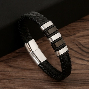 Close-up of black braided leather bracelet with magnetic clasp and metal accents