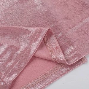 Dettaglio del tessuto metallico rosa e delle cuciture fini sull'abito formale