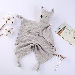 Close-up of gray cotton muslin baby security blanket with cat head and knotted corners