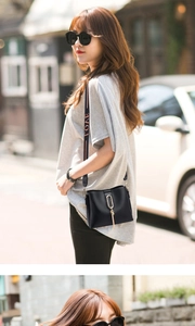 Detail of black bucket bag with a wide fabric shoulder strap featuring LOVE lettering