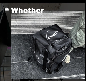 Detail view of large Oxford fabric backpack with reinforced side handles and logo