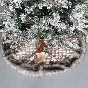 Knitted Christmas tree skirt featuring a gnome design and plush faux fur snowflake edge