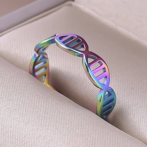 Macro detail of rainbow DNA helix ring in a beige jewelry box with polished finish