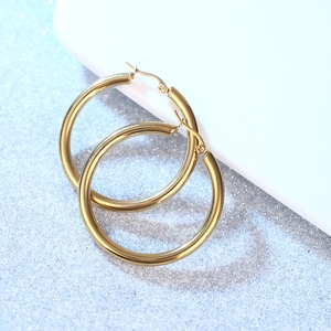 Polished gold hollow hoop earrings made of stainless steel for women in minimalist style