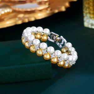 Macro shot of double-layer pearl bracelet with zircon flower charms on a velvet box