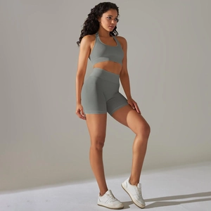 Detail showing seamless grey ribbed gym set with halter sports bra and high waist shorts