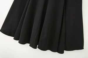Detail of the black midi dress hem showing the high-quality fabric texture and stitching