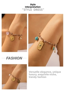 Detail of bohemian woven rope bracelet with gold embossed butterfly and flower charms