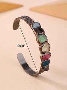 Close-up detail of vintage bronze cuff bracelet showing 6cm inner diameter and raw crystals