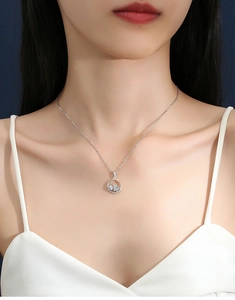 Macro shot of a S925 silver necklace featuring a hollow butterfly pendant on a model