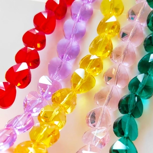 Macro shot of colorful faceted heart-shaped crystal glass beads for jewelry making