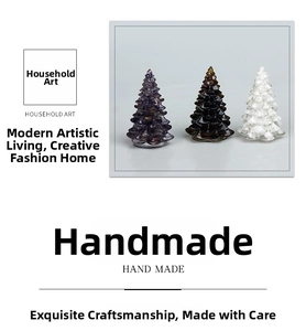 Close-up of three handmade crystal resin Christmas trees in purple, brown and clear tones